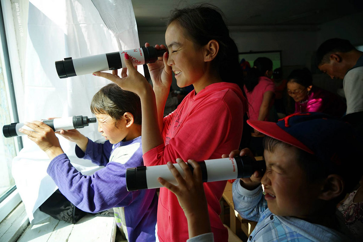 children using telescopes