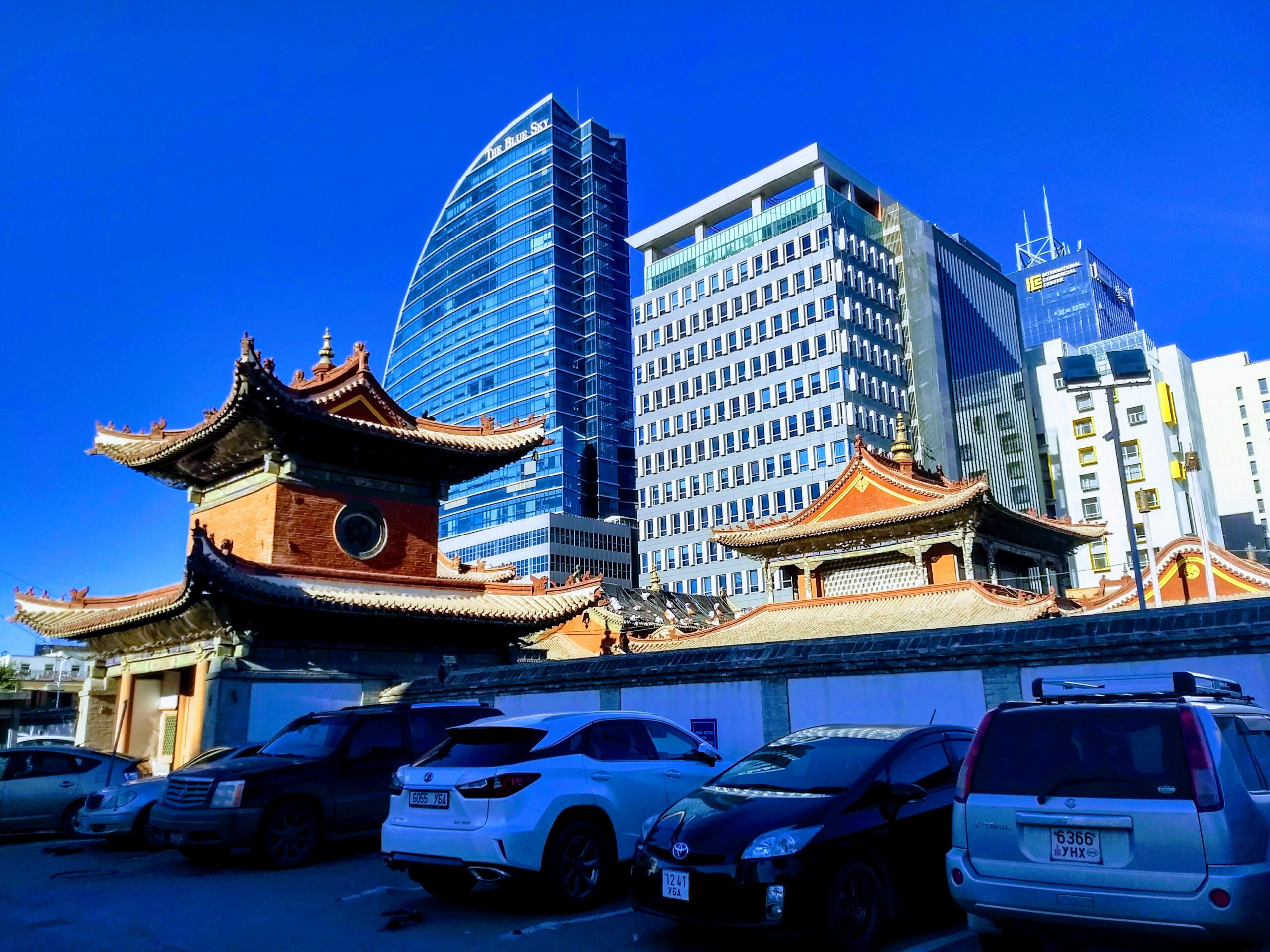 A photo of several city buildings behind an old Buddhist Temple in Ulaanbaatar.