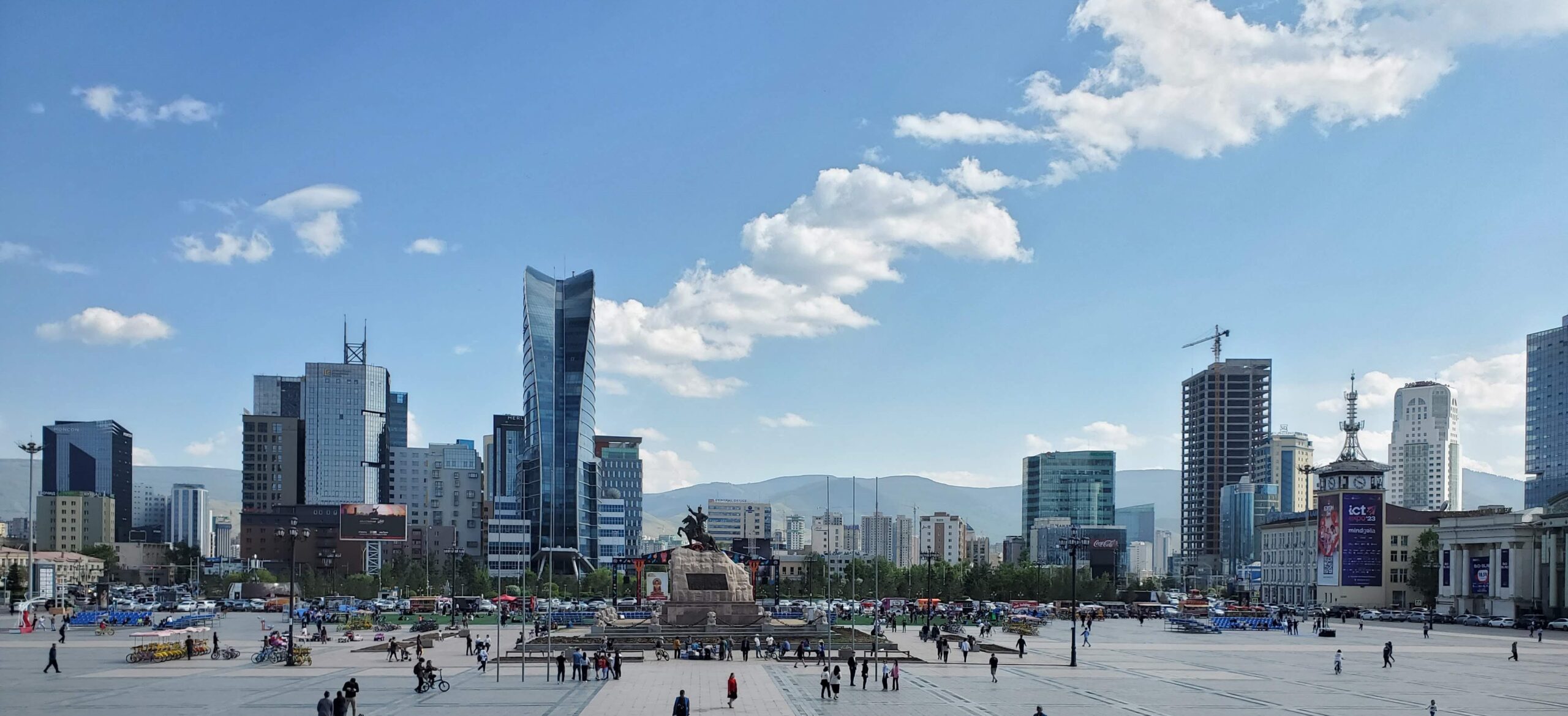 A panoramic view of the Ulaanbaatar city skyline looking out over a large central square.